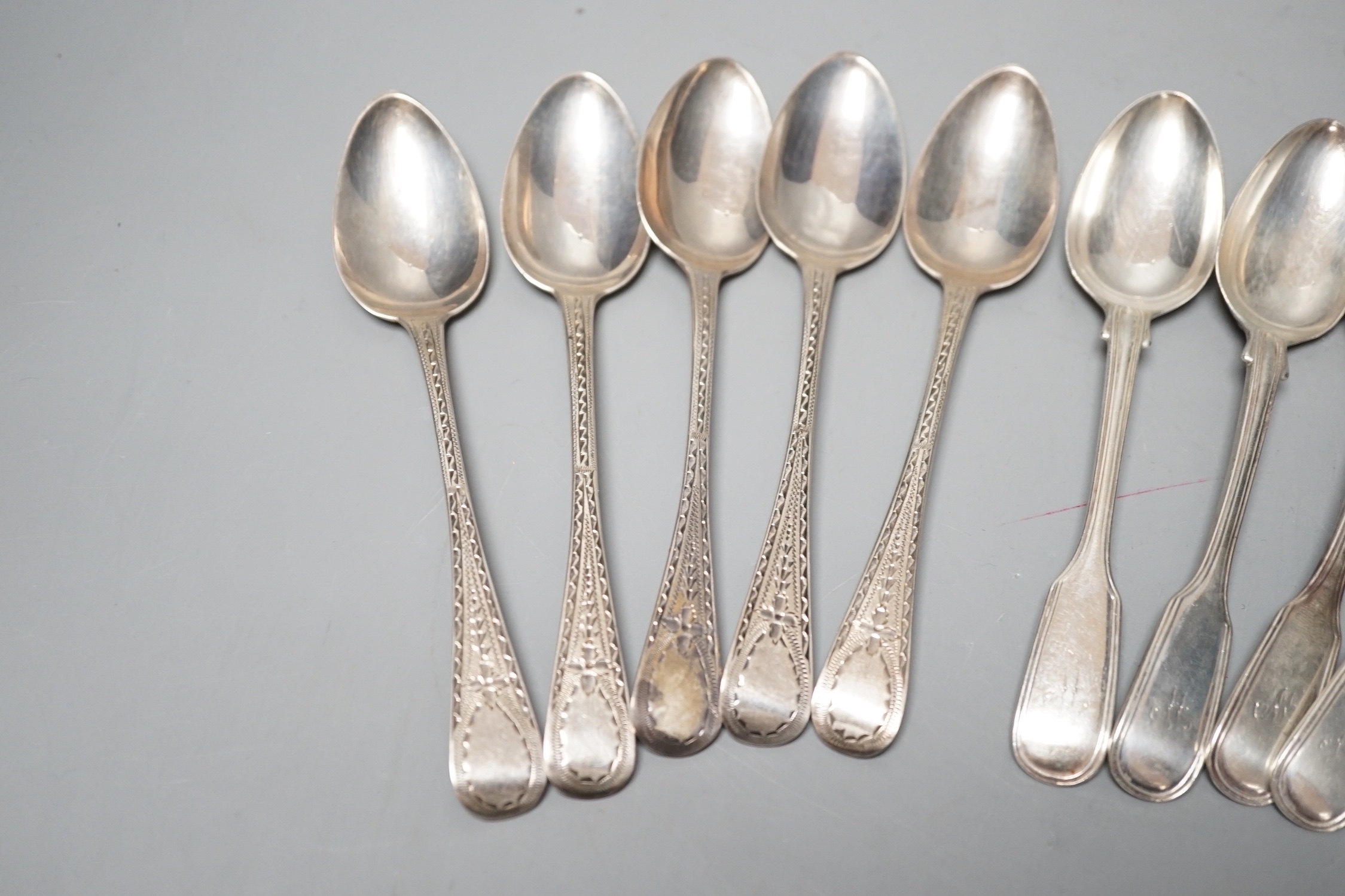 A set of six Victorian silver fiddle and thread pattern teaspoons, London, 1853 and a matched set of six Victorian silver bright cut engraved Old English pattern teaspoons, 9oz.